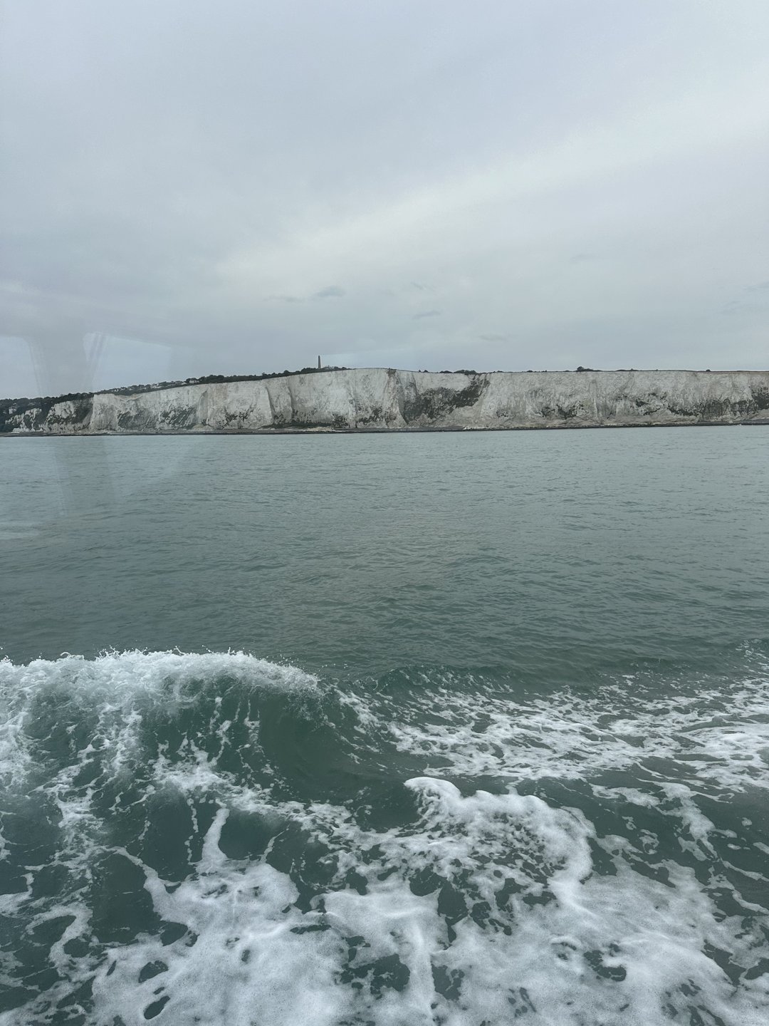 White cliffs near Dover seen from Che Bella Vita, with her wake below