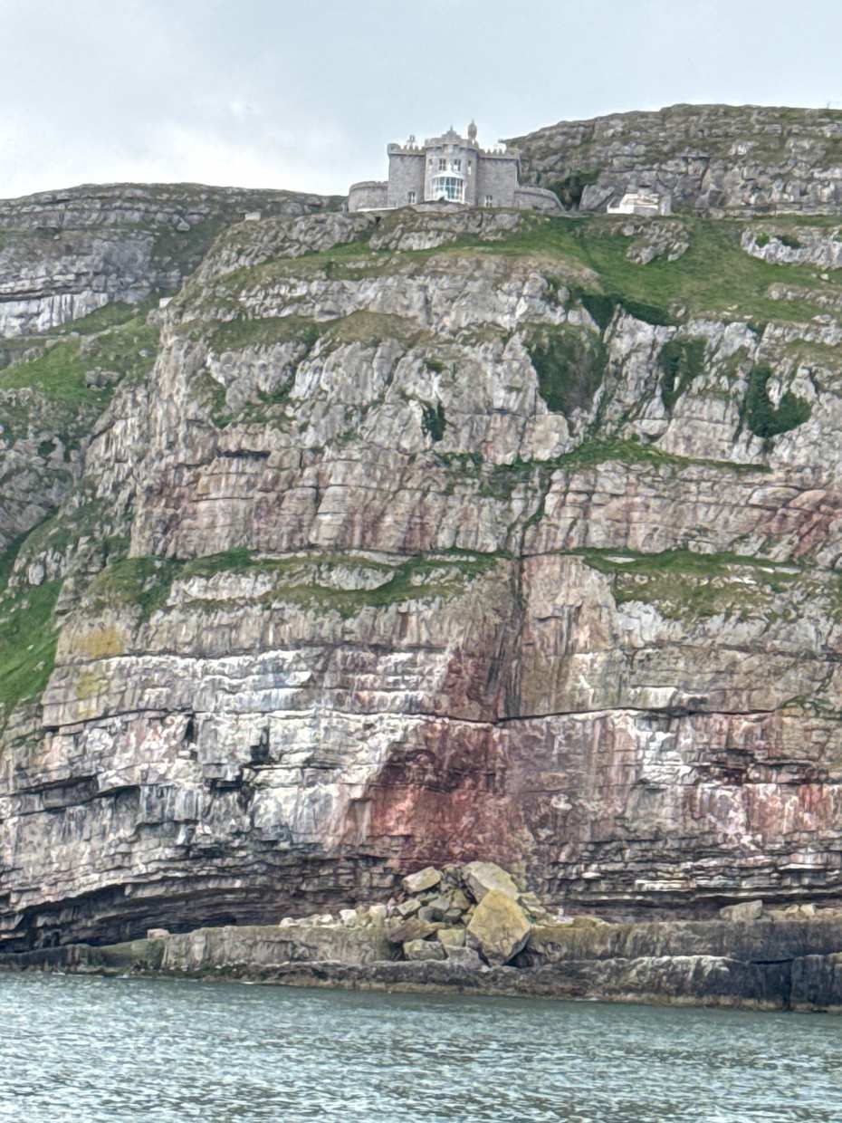 The Great Orme limestone cliffs rising above the sea at Llandudno