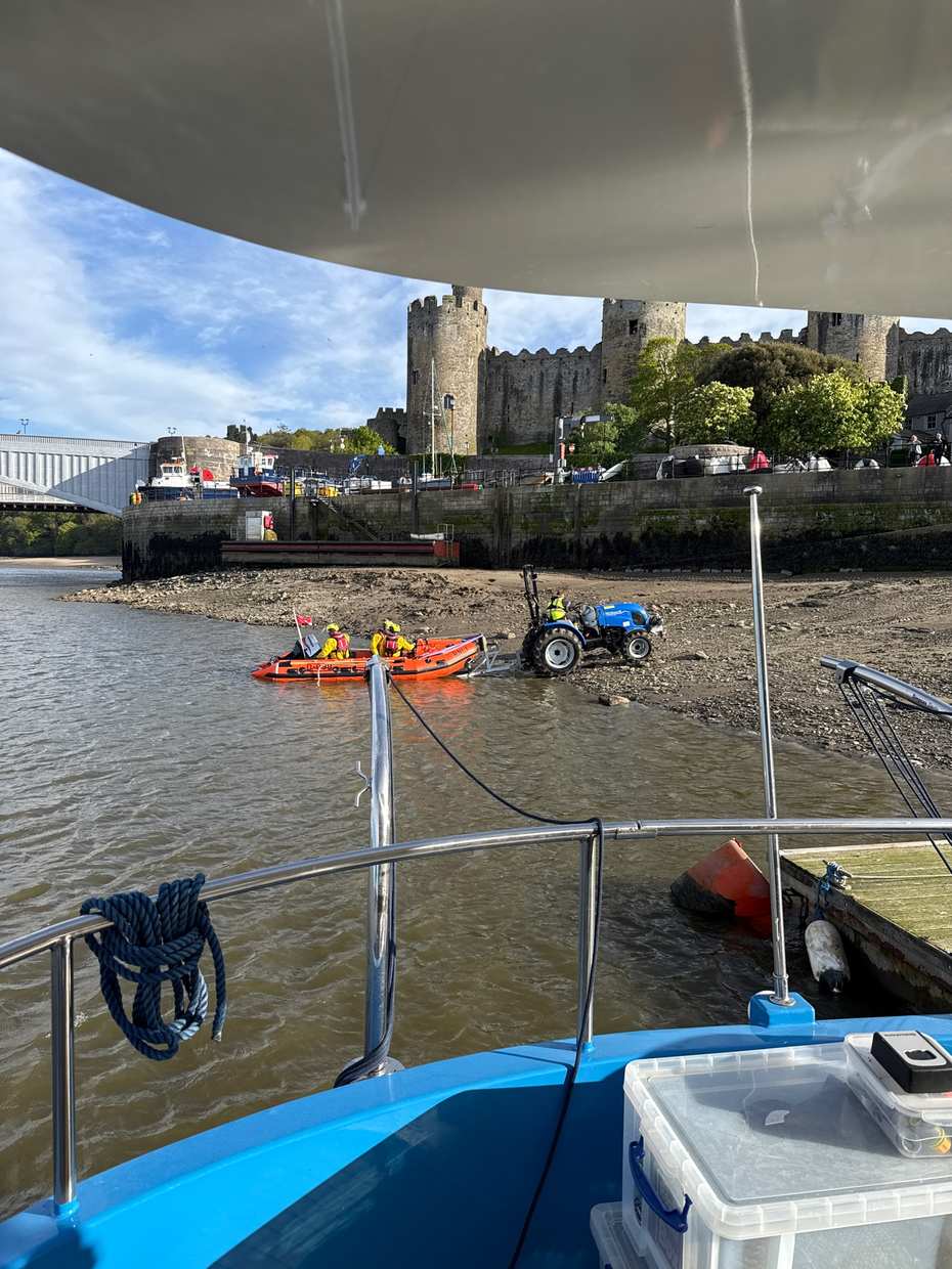 Conwy Castle and the harbour walls seen from the water