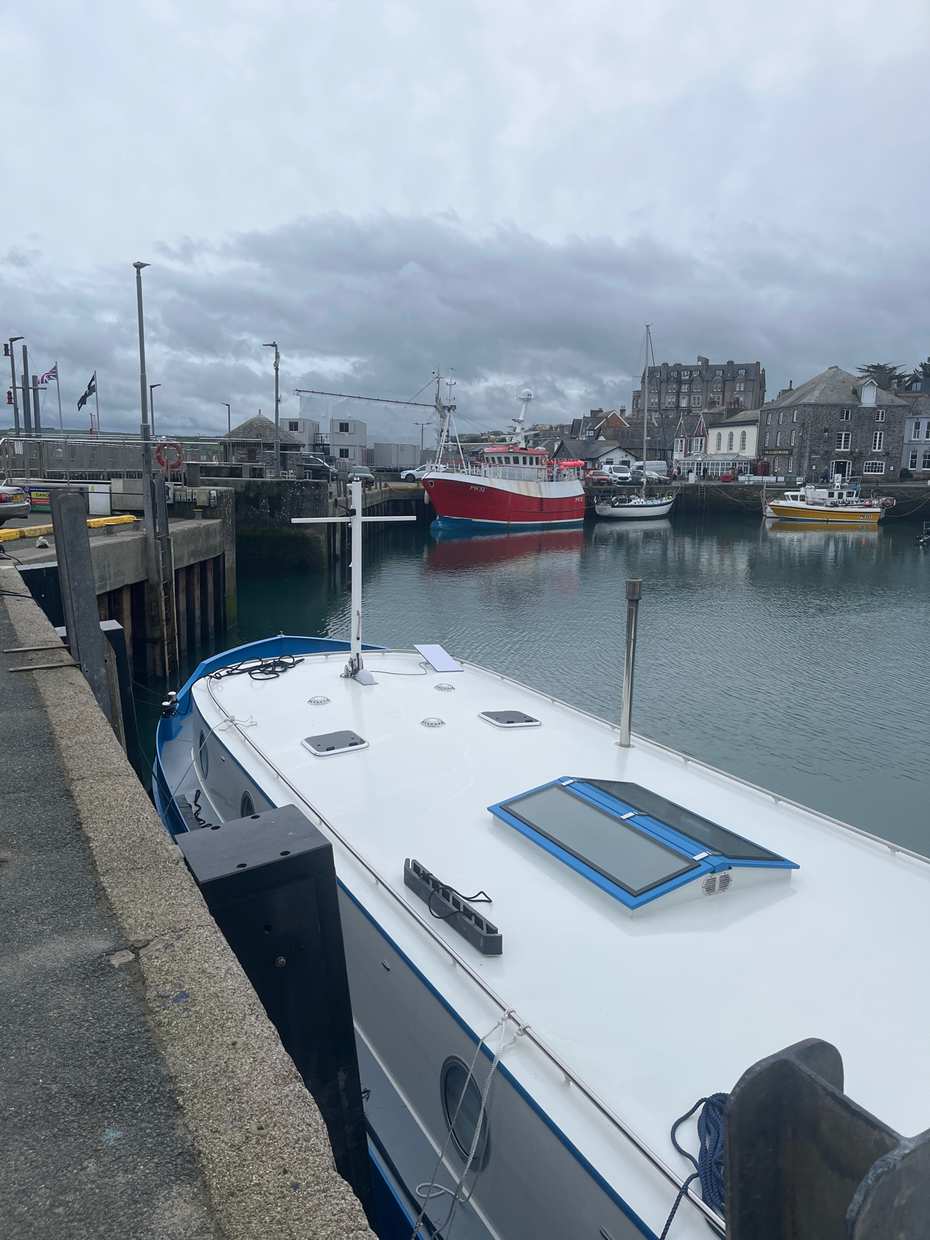 Padstow harbour with boats and the town beyond